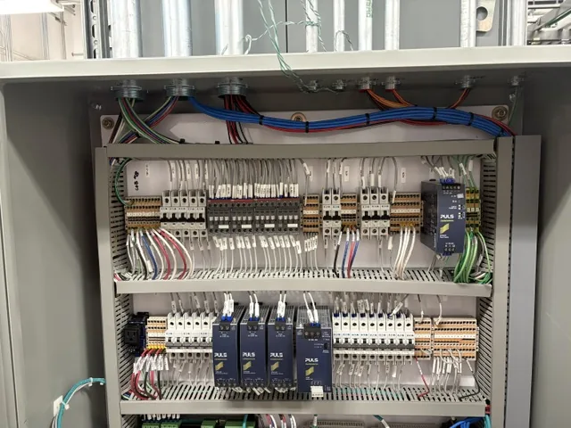 New Phase technician inspecting a critical power control panel during a preventive maintenance visit, Arizona
