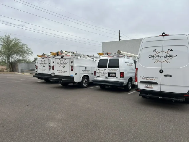 New Phase Electrical service fleet staged at an Arizona job site, desert backdrop